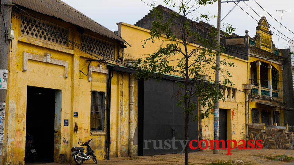 Old French era warehouses in District 8 Saigon, the graffiti in the distance reads 